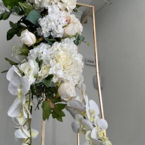 Elegant floral arrangement styled on a luxe gold frame